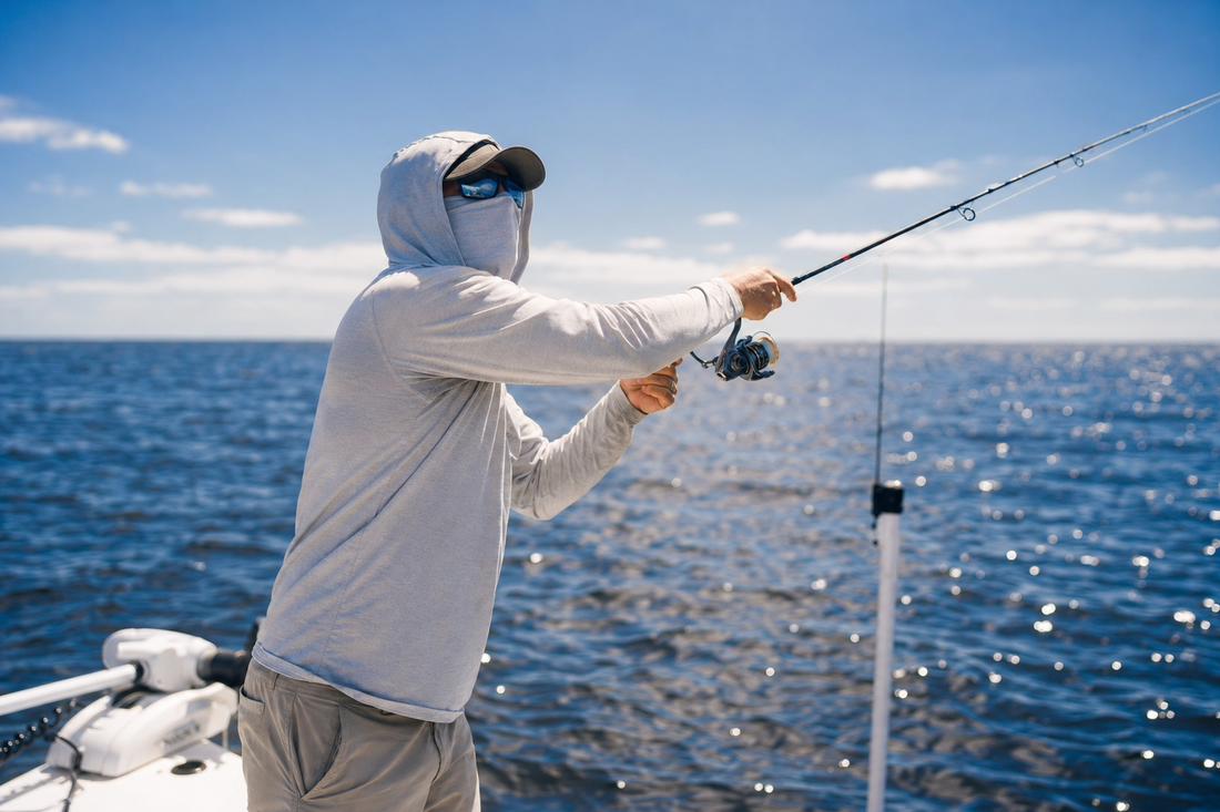 Angler in a hooded UV fishing shirt casting on open water