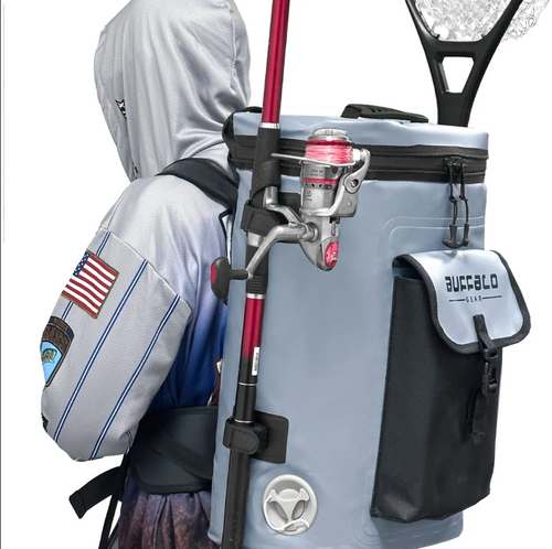31QT fish cooler backpack worn by an angler with fishing rods and landing net