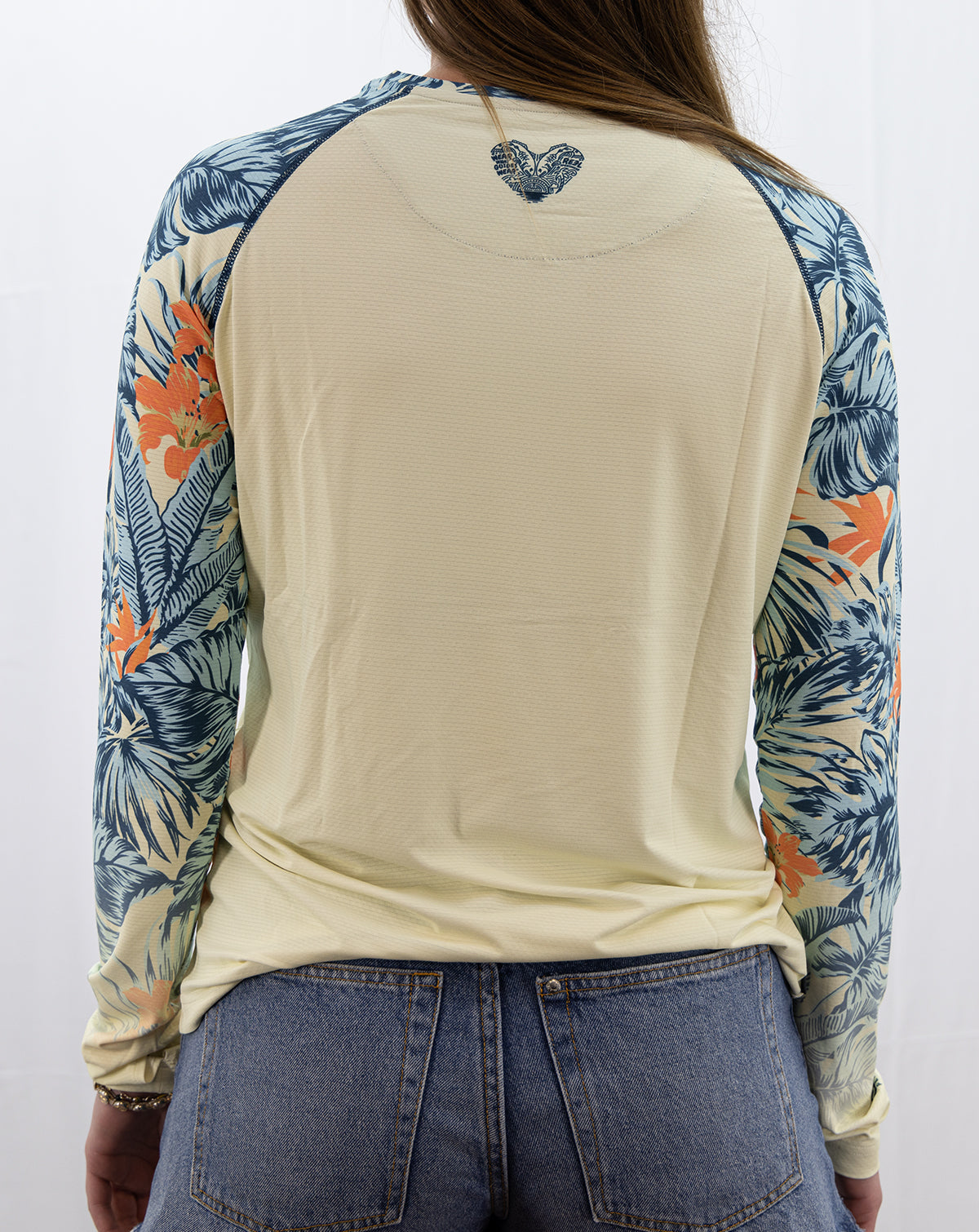 Back view of women’s Erin long-sleeve fishing shirt with blue and orange tropical-print sleeves