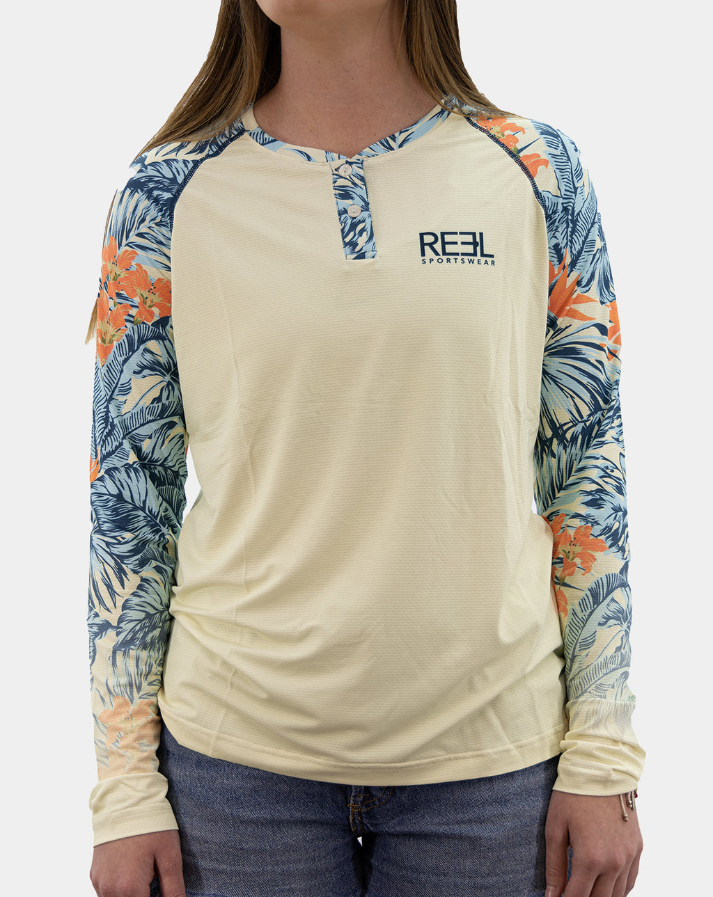 Front view of women’s Erin UPF 50+ Henley fishing shirt in blue and orange tropical print